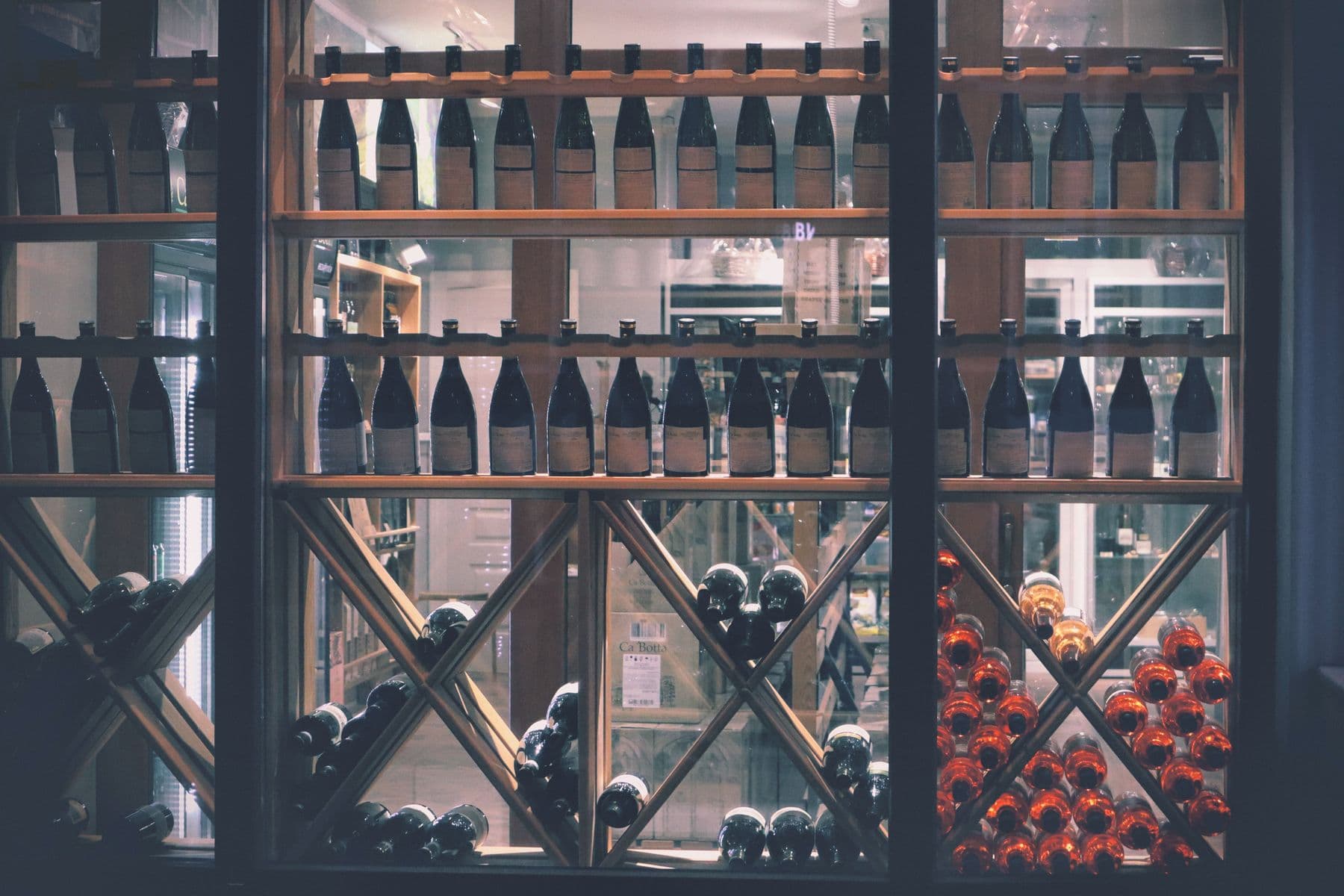 Wine bottles arranged on retail shelves